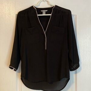 H&M black blouse with cream detailing. Front pockets. Button on sleeves.